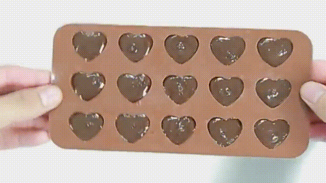 Sau đó cầm khuôn đặt với lực vừa đủ mạnh xuống bàn để socola được dàn trải đều ra. Sau đó cầm khuôn đặt với lực vừa đủ mạnh xuống bàn để socola được dàn trải đều ra.